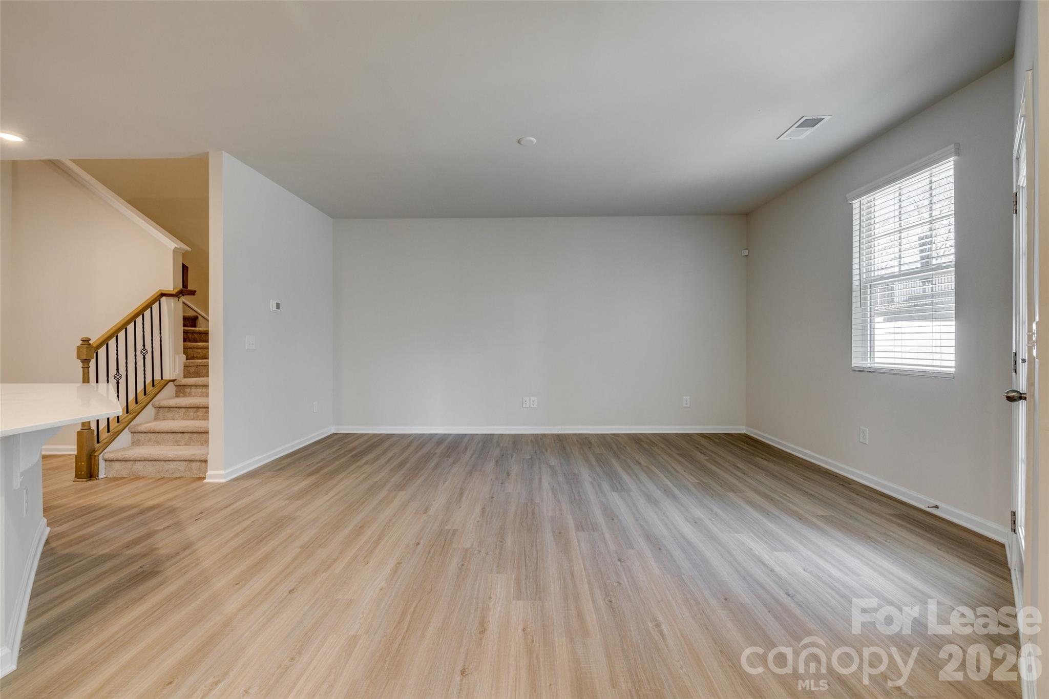 807 Gable Oak Lane Fort Mill, SC 29708 - Photo 12 of 39 a view of an empty room with wooden floor and window