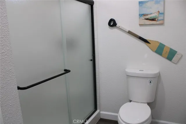 a bathroom with a toilet and a shower