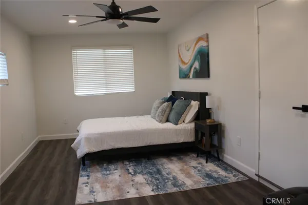 a bed sitting in a bedroom next to a window