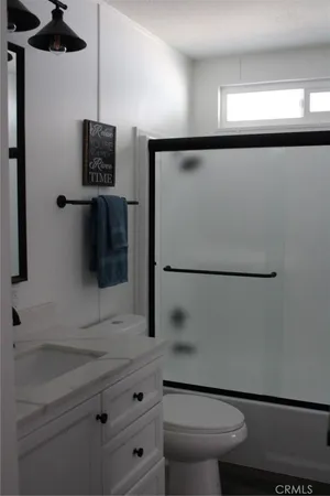 a bathroom with a shower a toilet and sink