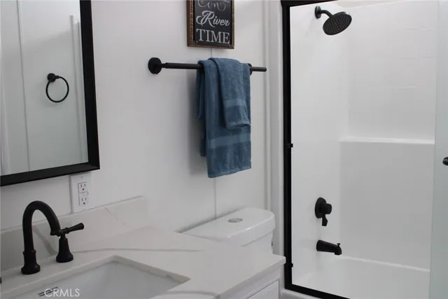 a bathroom with a tub sink and mirror