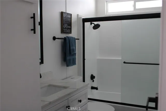 a bathroom with a shower and a sink