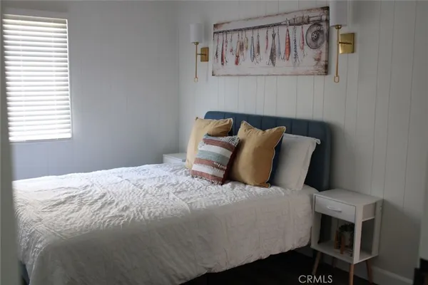 a large bed sitting in a bedroom next to a window