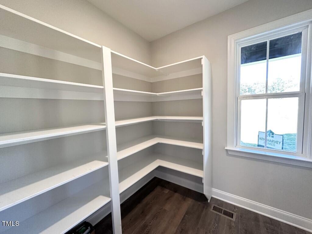 1345 Wiley Road Spring Hope, NC 27882 - Photo 4 of 15 a view of an empty room with a window and wooden floor