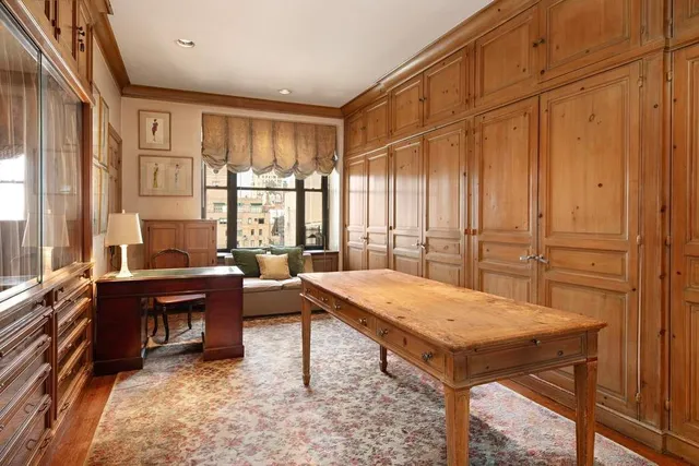 a living room with furniture a large window and a chandelier