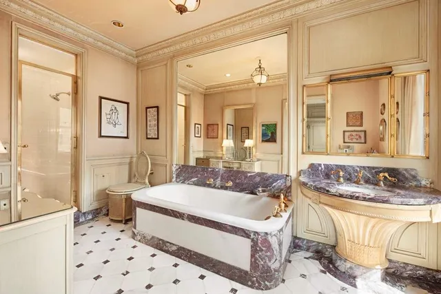 a spacious bathroom with a tub sink and shower