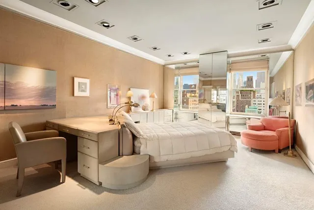 a spacious bedroom with a bed and a couch