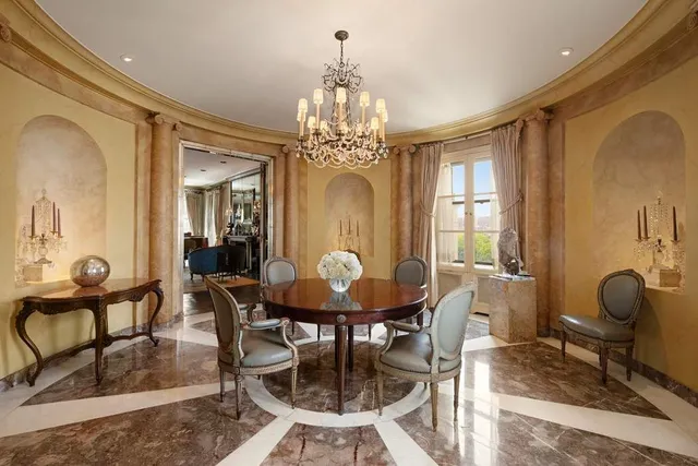 a view of a dining room with furniture and chandelier