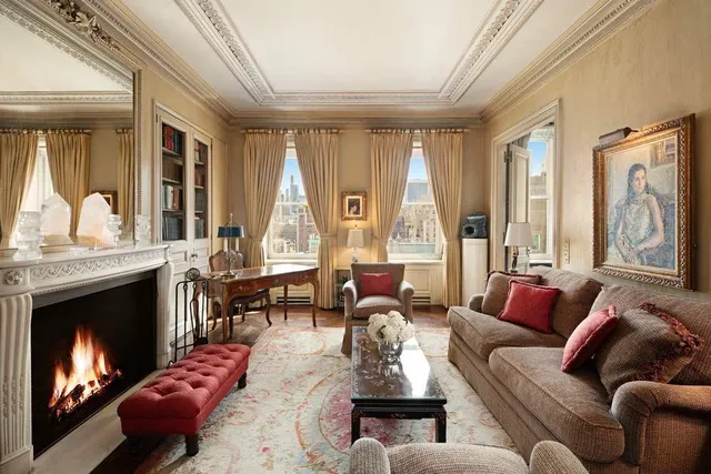 a living room with furniture fireplace and a large window