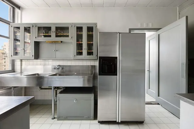 a kitchen with stainless steel appliances granite countertop a refrigerator and a sink