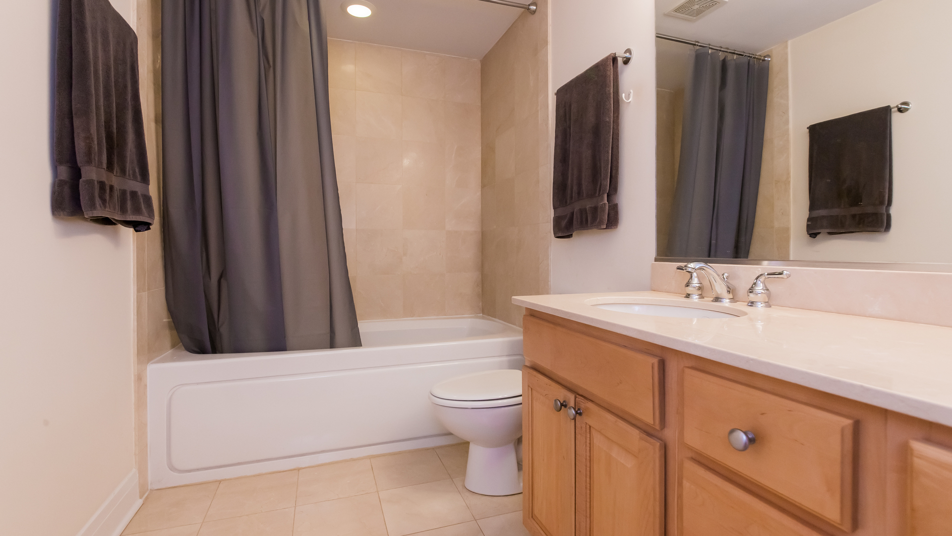 6963 North Sheridan Road, Unit 1E Chicago, IL 60626 - Photo 18 of 20 a bathroom with a granite countertop sink toilet and mirror