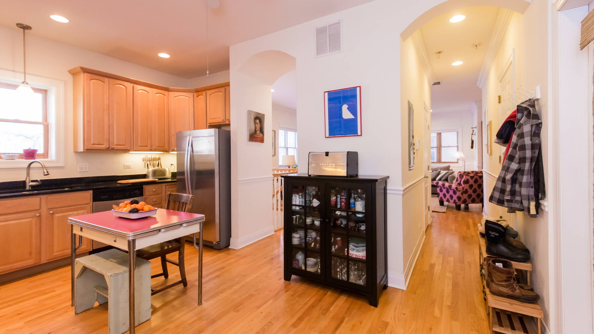 6963 North Sheridan Road, Unit 1E Chicago, IL 60626 - Photo 9 of 20 a kitchen with stainless steel appliances kitchen island granite countertop a refrigerator and a stove top oven
