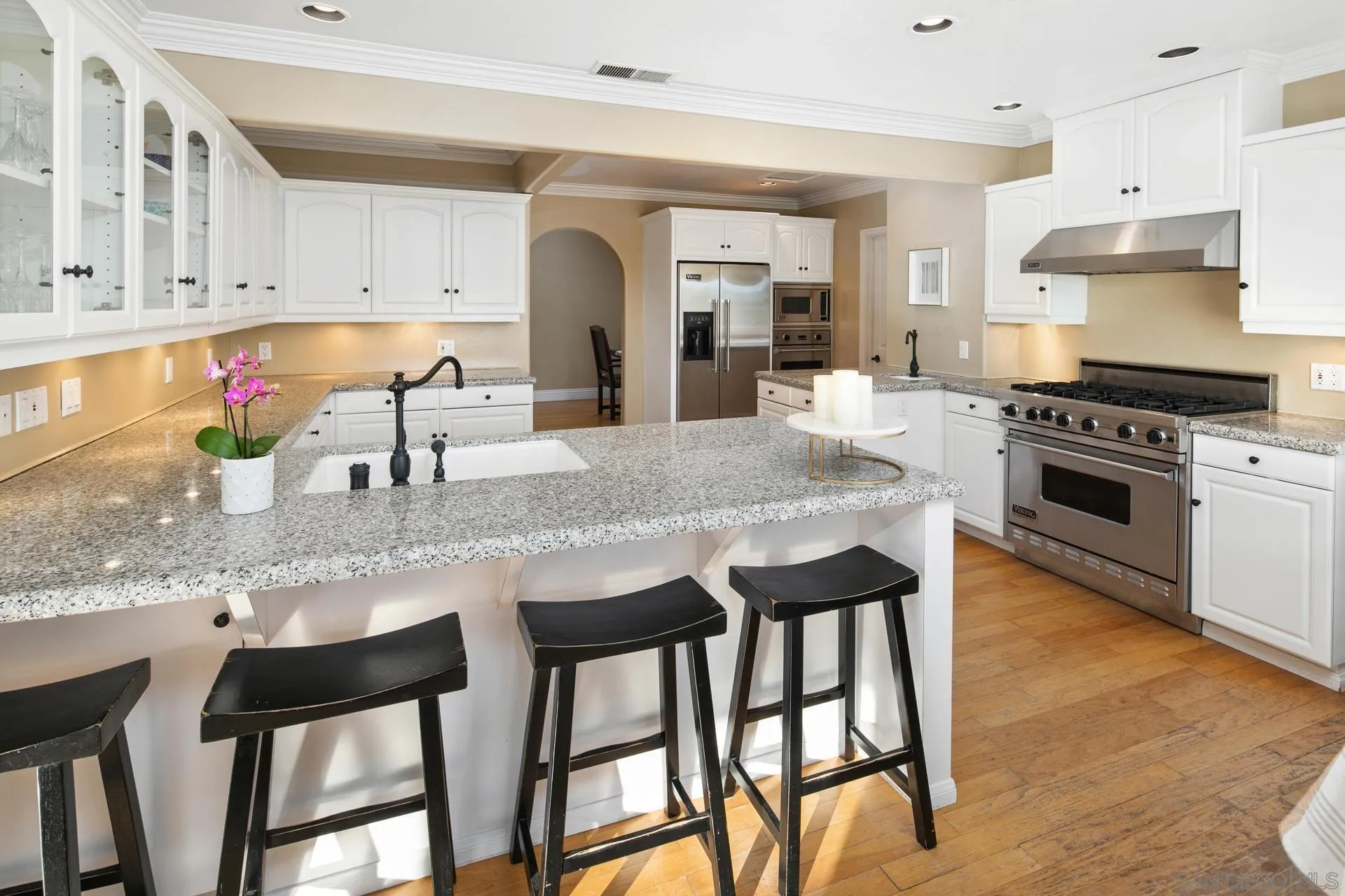 6347 Las Colinas Rancho Santa Fe, CA 92067 - Photo 8 of 24 a kitchen with granite countertop a table chairs stove and cabinets