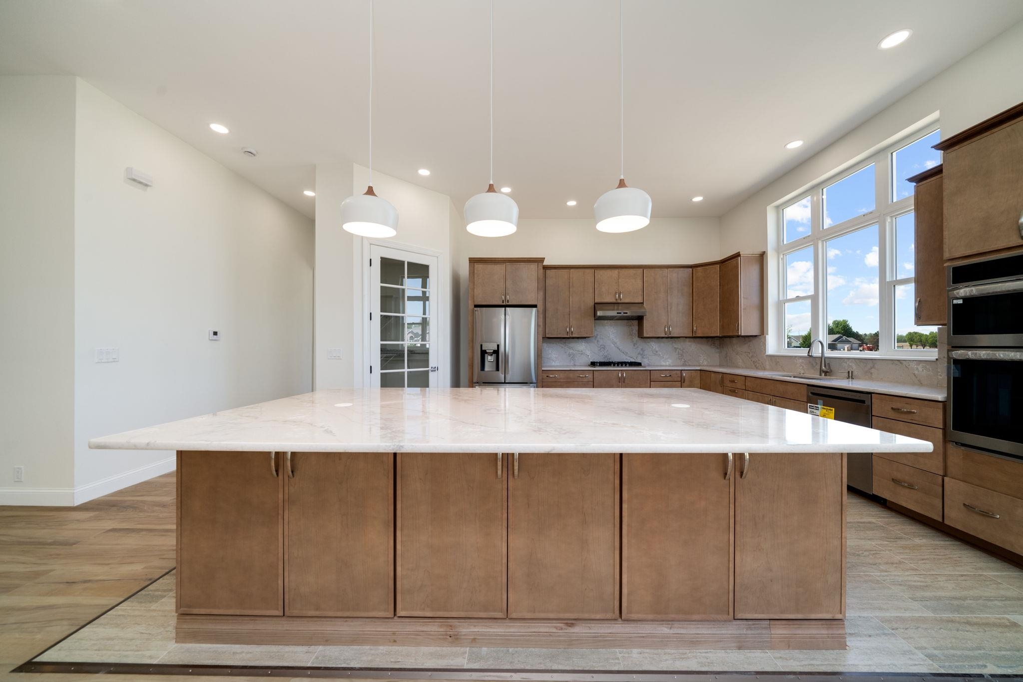 5145 Sycamore Ridge Road Belvidere, IL 61008 - Photo 12 of 57 a large kitchen with a large counter top stainless steel appliances and cabinets