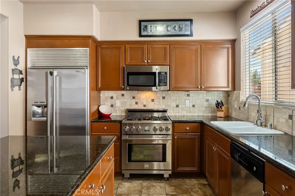 a kitchen with refrigerator and furniture