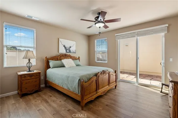 a bedroom with a bed and a ceiling fan