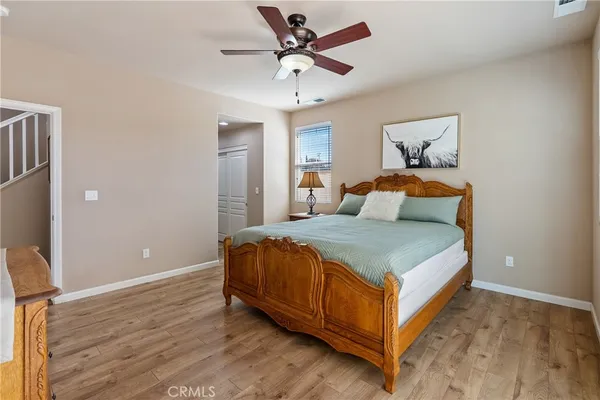 a view of a hallway with a livingroom and a bathroom with a sink