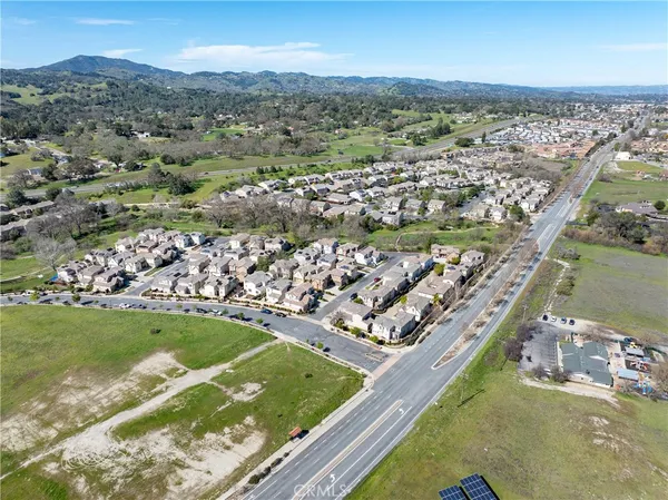 a view of a patio with a table and chairs under an umbrella
