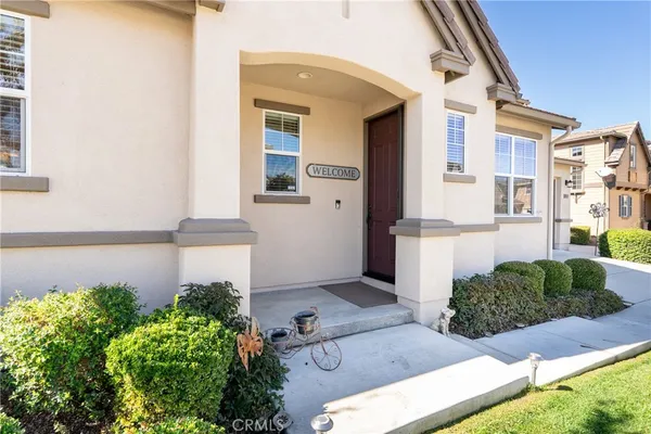 a front view of a house with plants