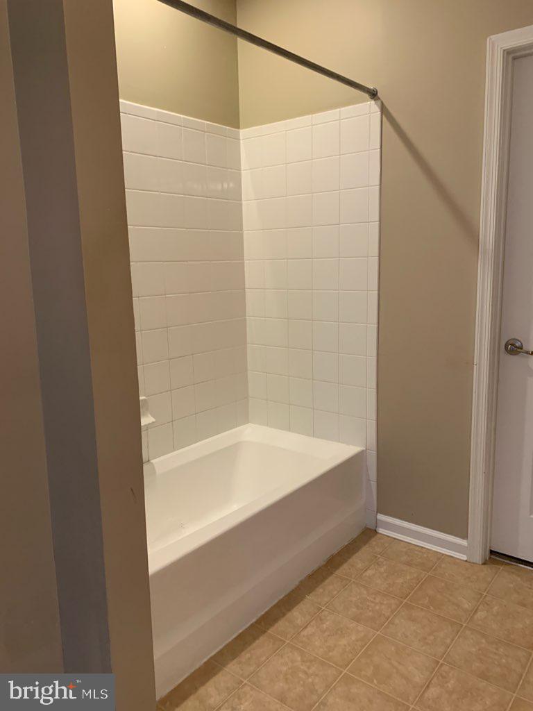 36405 Ridgeshore Lane Millville, DE 19967 - Photo 11 of 22 a bathroom with a bathtub and a shower