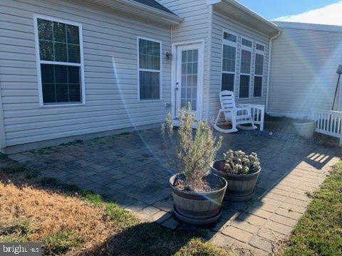 36405 Ridgeshore Lane Millville, DE 19967 - Photo 20 of 22 a view of a porch with a dining table and chair