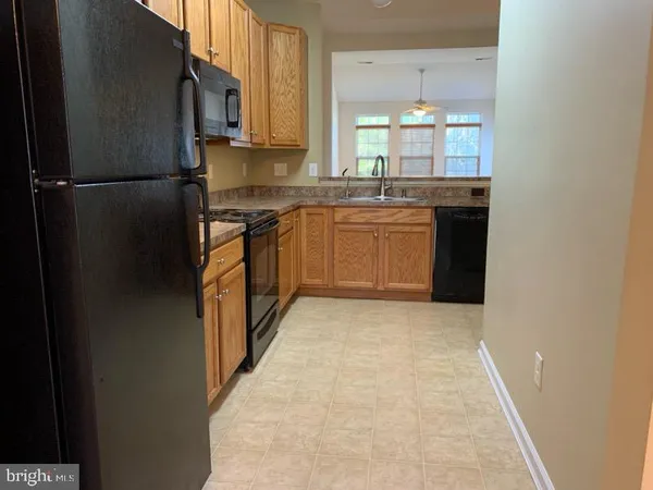 a kitchen with a sink stove and refrigerator