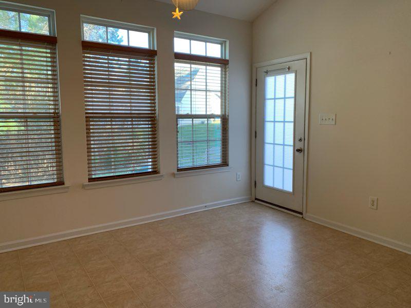 36405 Ridgeshore Lane Millville, DE 19967 - Photo 8 of 22 an empty room with wooden floor and windows