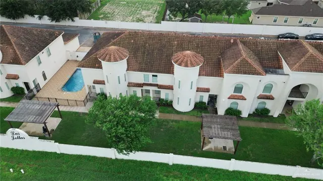 an aerial view of a house with a yard