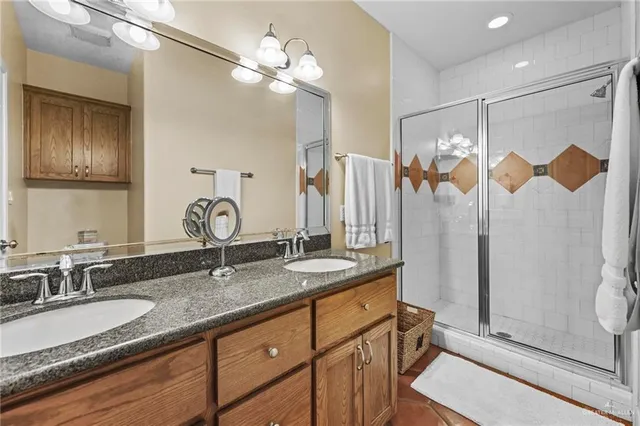 a spacious bedroom with a bed window and a ceiling fan
