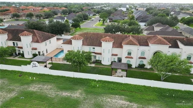 an aerial view of residential houses with outdoor space and street view
