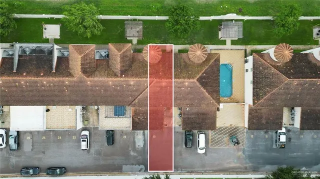an aerial view of a house with garden space and street view