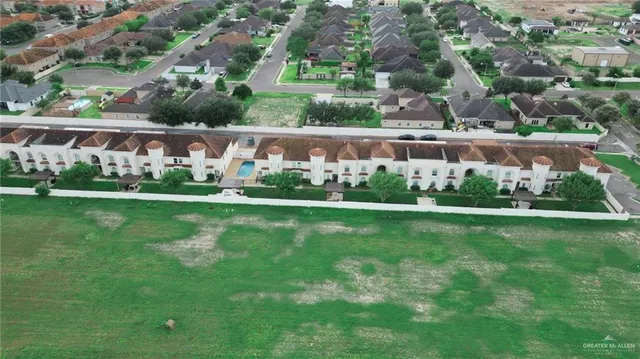 an aerial view of a house with a yard