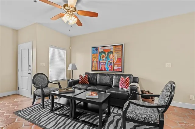 a living room with furniture a rug and a window