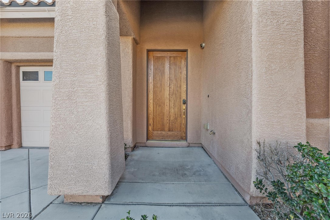 11425 Rancho Portena Avenue Las Vegas, NV 89138 - Photo 14 of 58 Property entrance with stucco siding