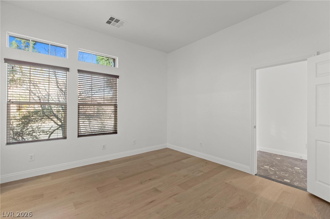 11425 Rancho Portena Avenue Las Vegas, NV 89138 - Photo 16 of 58 Spare room featuring baseboards and light wood-style flooring