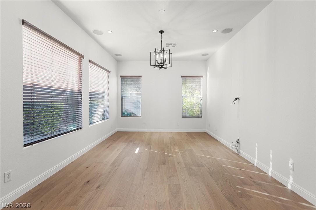 11425 Rancho Portena Avenue Las Vegas, NV 89138 - Photo 20 of 58 Unfurnished dining area with light wood-type flooring and suspended lighting