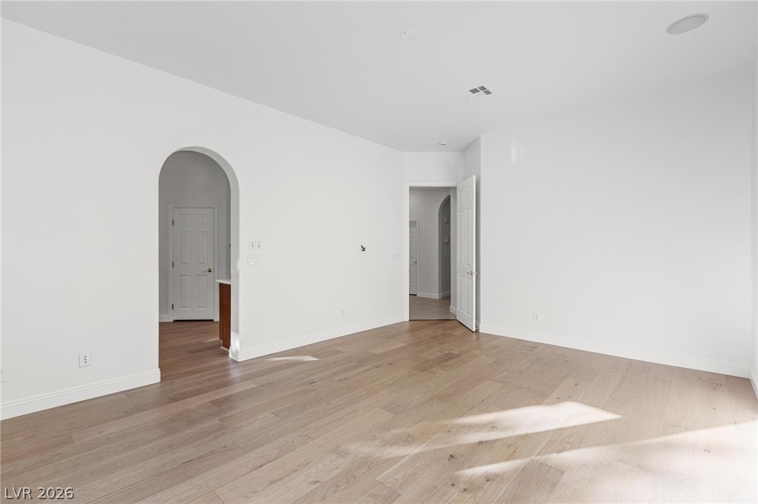 11425 Rancho Portena Avenue Las Vegas, NV 89138 - Photo 33 of 58 Unfurnished room with arched walkways and light wood finished floors