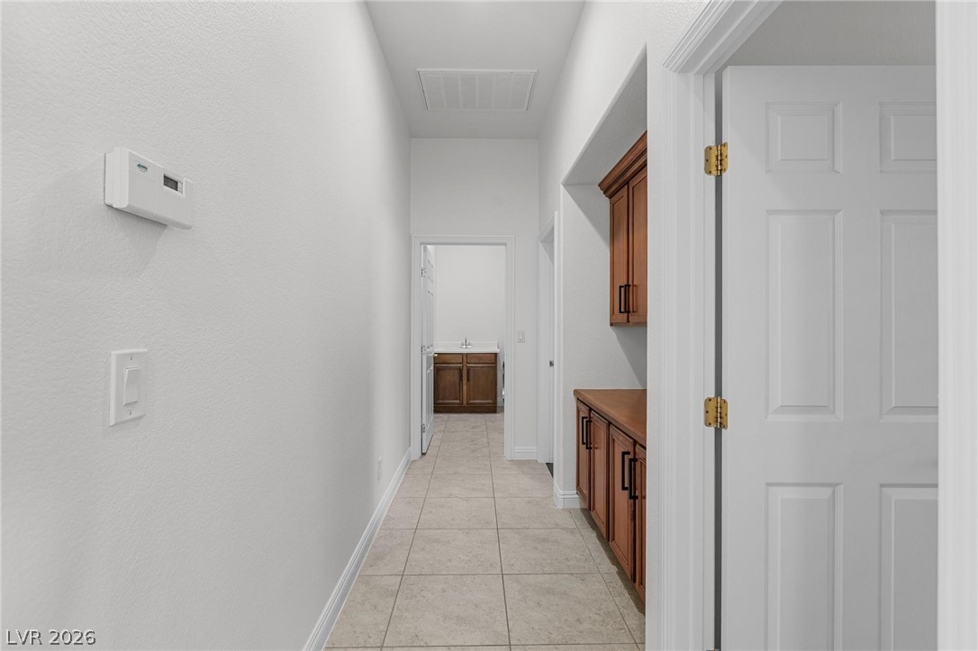 11425 Rancho Portena Avenue Las Vegas, NV 89138 - Photo 37 of 58 Hall with baseboards and light tile patterned flooring