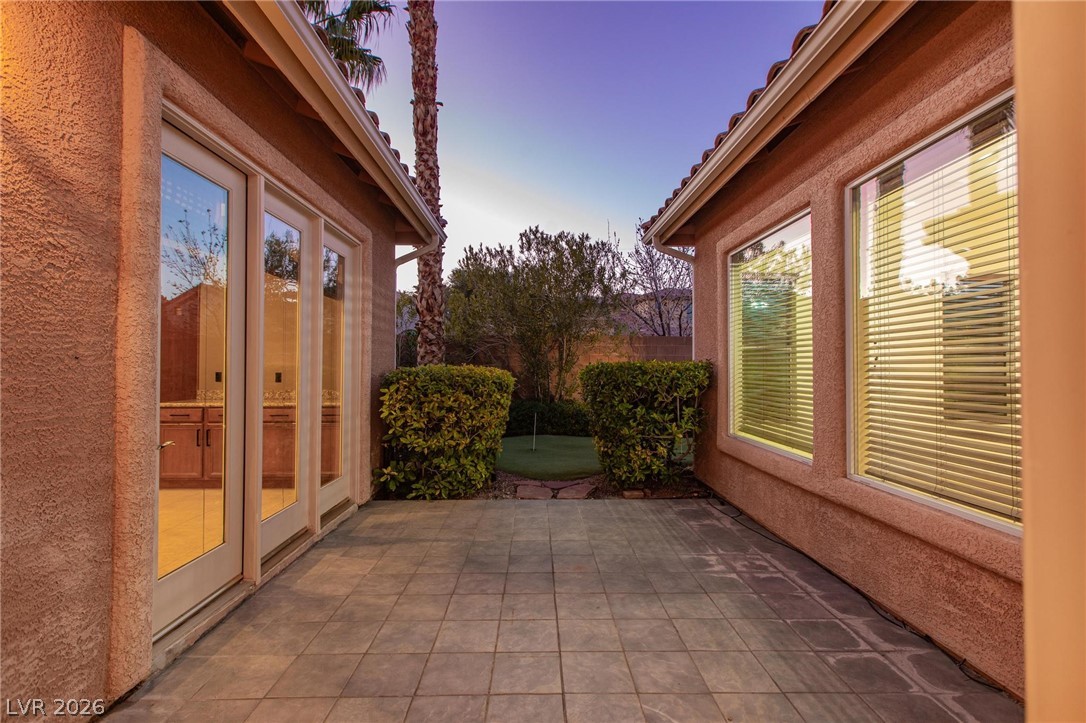 11425 Rancho Portena Avenue Las Vegas, NV 89138 - Photo 4 of 58 Patio terrace at dusk featuring a patio