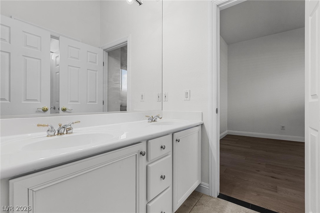 11425 Rancho Portena Avenue Las Vegas, NV 89138 - Photo 40 of 58 Bathroom featuring double vanity and light wood-style flooring