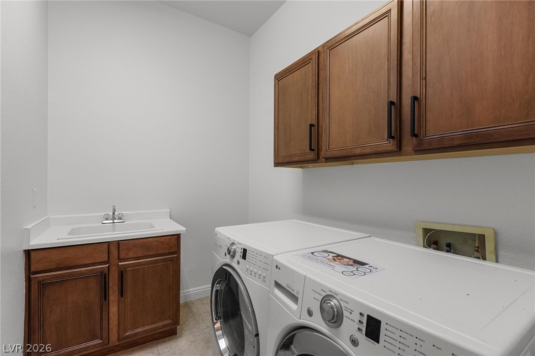 11425 Rancho Portena Avenue Las Vegas, NV 89138 - Photo 44 of 58 Laundry area featuring cabinet space, independent washer and dryer, and light tile patterned flooring