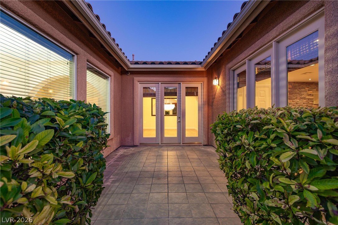 11425 Rancho Portena Avenue Las Vegas, NV 89138 - Photo 5 of 58 Doorway to property featuring a tiled roof and stucco siding