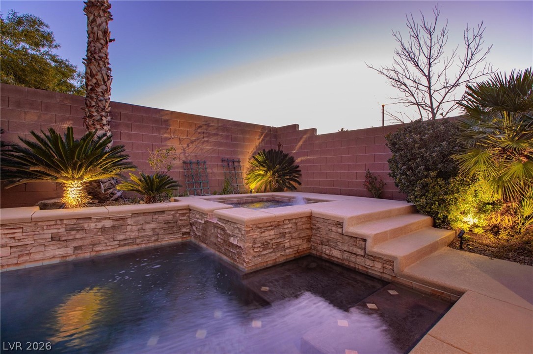 11425 Rancho Portena Avenue Las Vegas, NV 89138 - Photo 9 of 58 Fenced backyard featuring an in-ground hot tub and a patio area