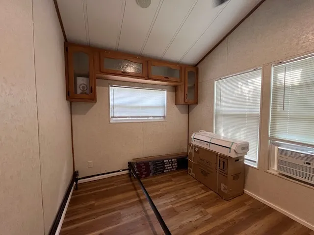 a room with wooden floor and window
