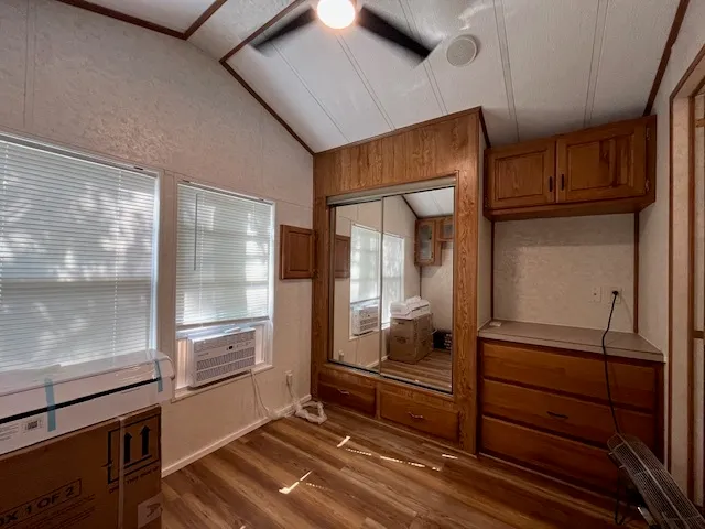 a kitchen with granite countertop a refrigerator and cabinets