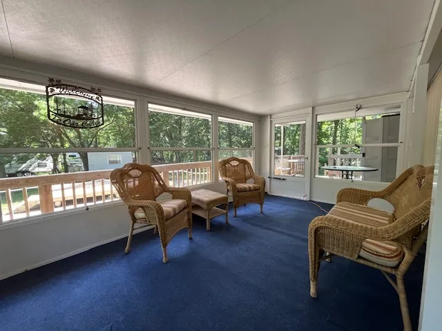a view of a chairs and table in the balcony