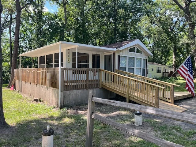 a front view of a house with a yard table and chairs