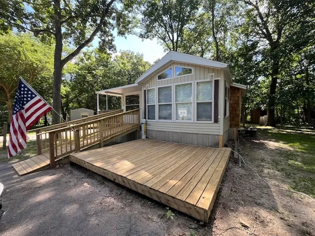 a view of a house with a small yard and wooden fence
