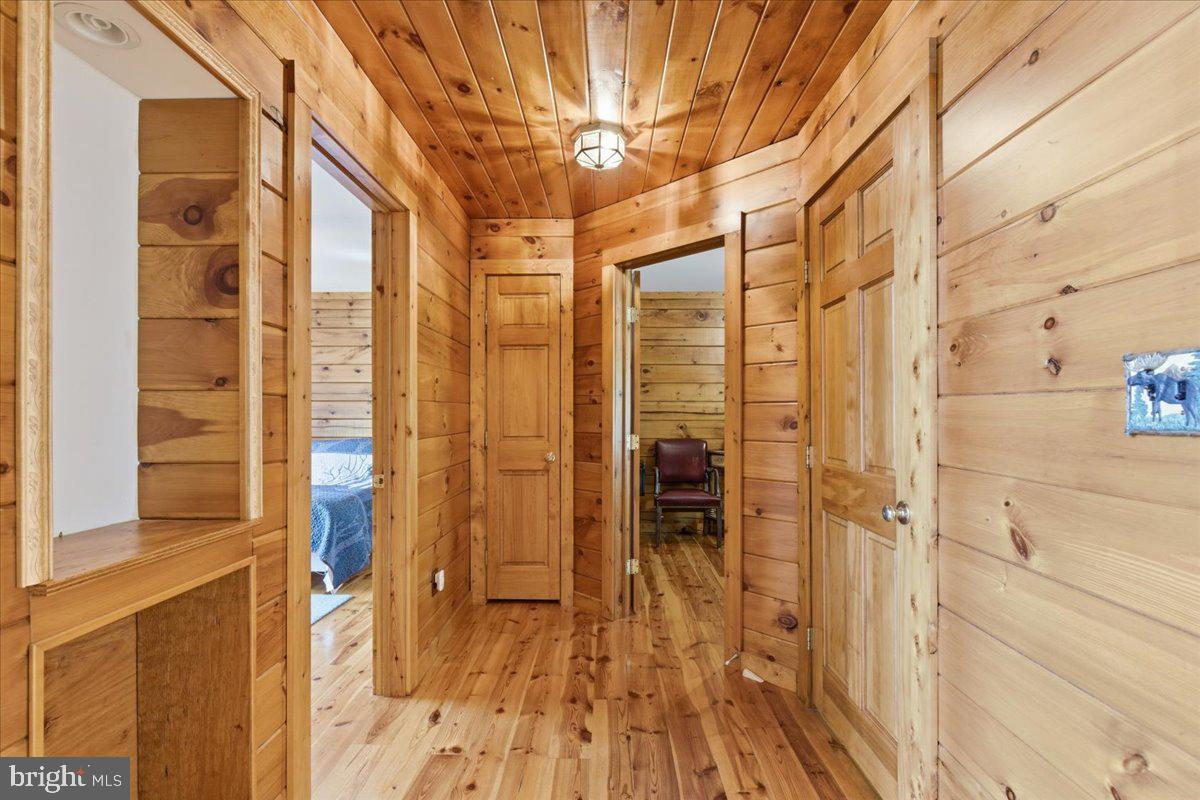 15240 Sheads Mountain Road Rixeyville, VA 22737 - Photo 20 of 70 Warm wooden hallway invites exploration.