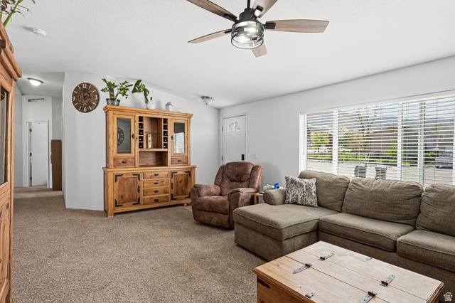 1637 East Midvalley Road Enoch, UT 84721 - Photo 6 of 48 Living room with carpet, a ceiling fan, and vaulted ceiling